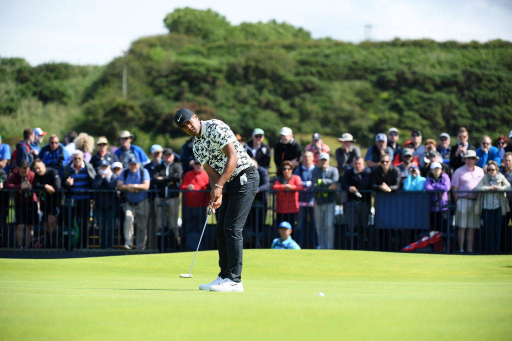 Tony Finau watching his putt roll towards the hole